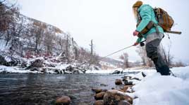Fishwest employee and guide Andrea Jeffery working a run on the Middle Provo River.