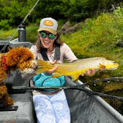 Fishwest Social Media Coordinator, Holly Jones, and her dog Major showing off a truly spectacular brown trout caught while floating Utah’s iconic Green River.