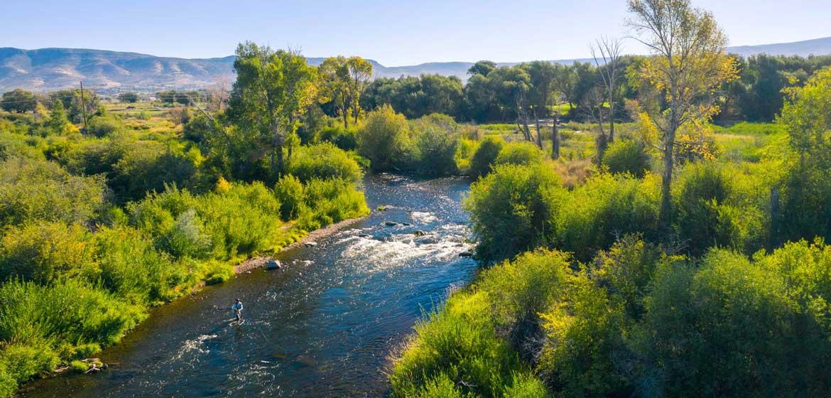 Aerial view of a fisherman casting on a river in Northern Utah