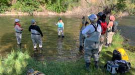 Three women fly fish from a boat in Wyoming