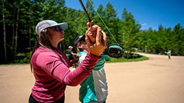 Brooke Bailey teaching casting fundamentals to a student of the Women’s Intro To Fly Fishing class