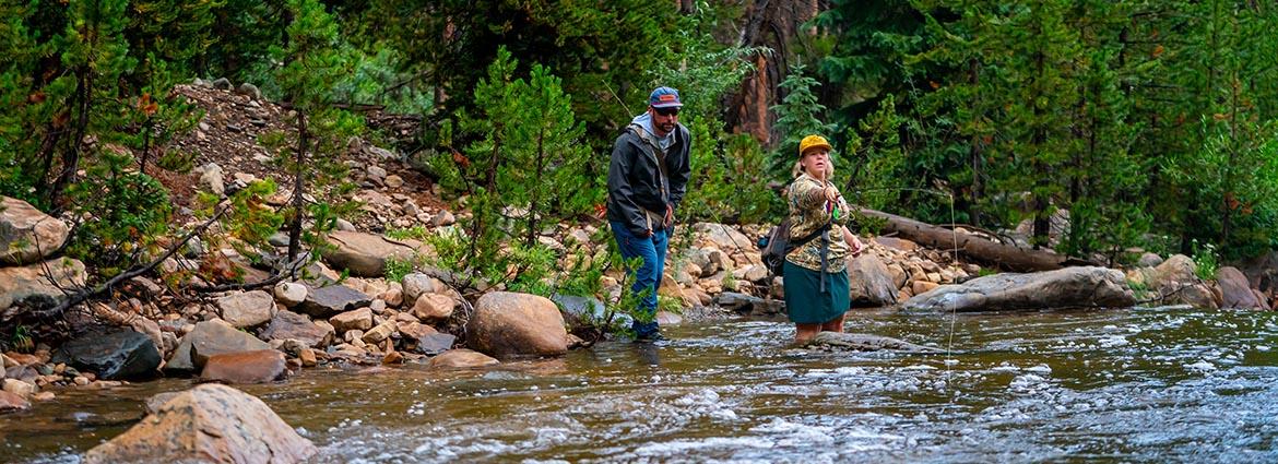 An angler and guide exploring a backcountry creek in the Uinta National Forest in Northern Utah