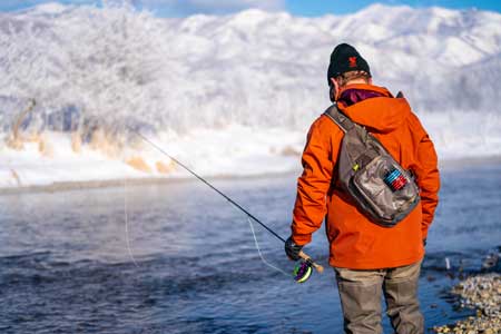 JC weeks makes a cast at sunrise on the Weber River.