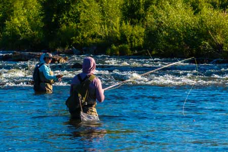 Two Anglers fishing Utah’s Provo river during a beautiful sunny day in June.