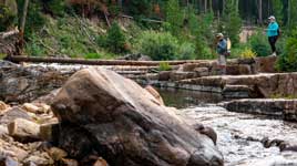 Fishwest employee JC Weeks plays a brook trout on a lake in the Uinta Mountains in Northern Utah.