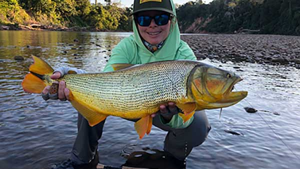 Fishwest staff Brooke Bailey posing with the golden dorado she caught