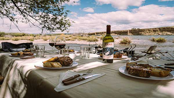 Table set up with an Patagonia dinner of steak and wine