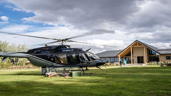 The helicopter warms up in front of the Chochoy lodge