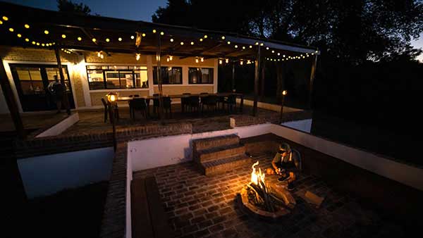 Itati lodge and its two decks, with a lit fire.