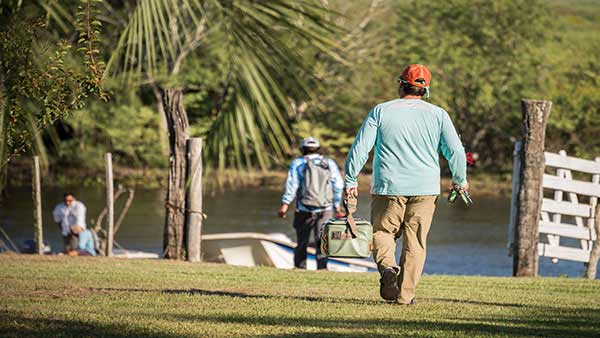 Two anglers approach a boat while they prepare to fish for golden dorado in Argentina