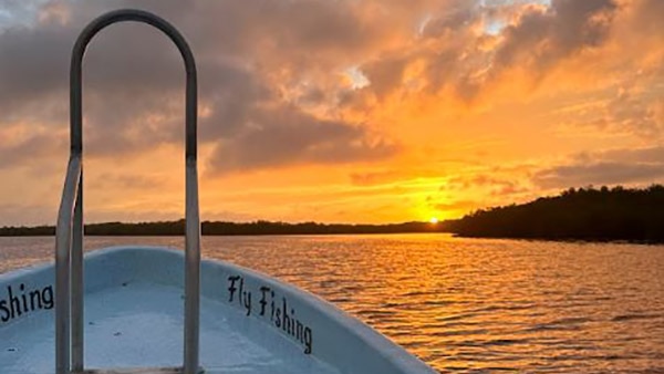 A beautiful sunset view from the front of a panga near the Tarpon CCay Lodge.