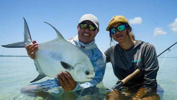 Fishwest Ambassador Alan Beltran guiding a good friend into a Permit on the flats of Chetumal Bay outside of Xacalak. Mexico