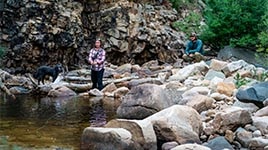A fly fisherman fishing a pool in the Uinta National forest on a beautiful evening