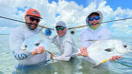 Xcalak Mexico, a Permit anglers paradise. Two anglers showcasing a “Permit Double” caught with Fishwest Ambassador Alan Beltran.