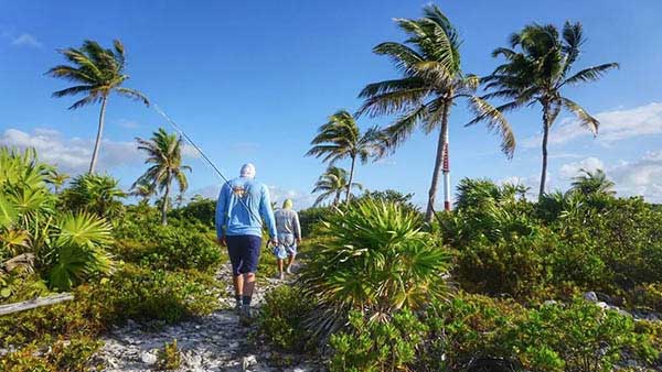 Two anglers hiking into one of the many oceanside flats north of Xcalak on a recent Fishwest Hosted Trip.