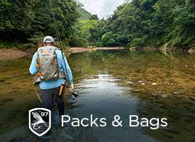 An angler hiking a river in the Bolivian Jungle using a Fishpond Thunderhead